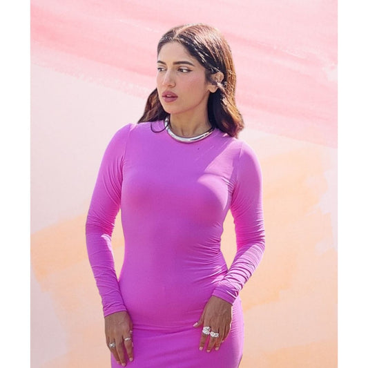 Bhumi wearing Stacey Stack Rings with a pink form-fitting dress against a pastel background.