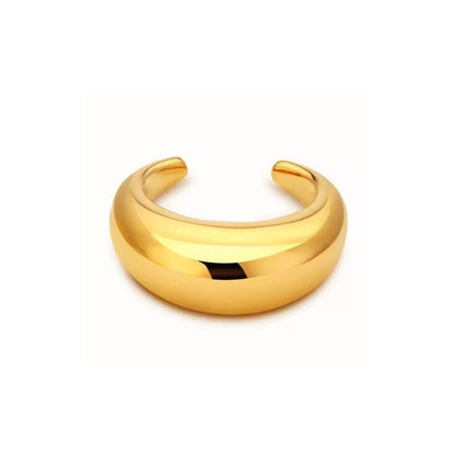 The LUNA CUFF by AEQEA is a thick, 22k gold-plated cuff bracelet with a smooth, rounded surface and open back, shown on a plain white background—a striking statement piece.